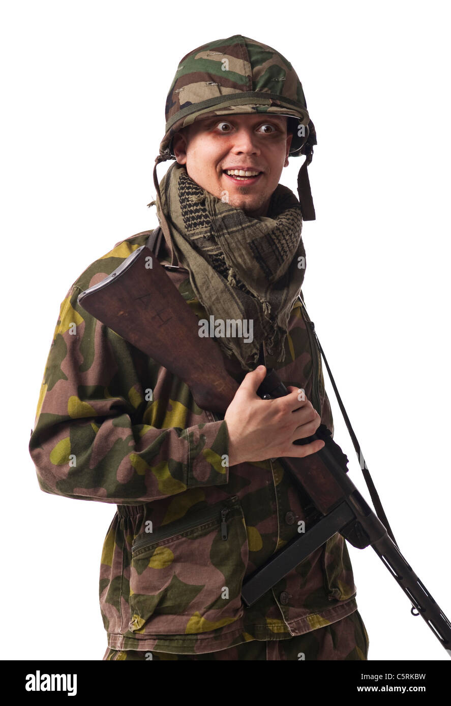 Ein goofy Soldat mit Helm, Maschinengewehr und lustige Augen. Stockfoto