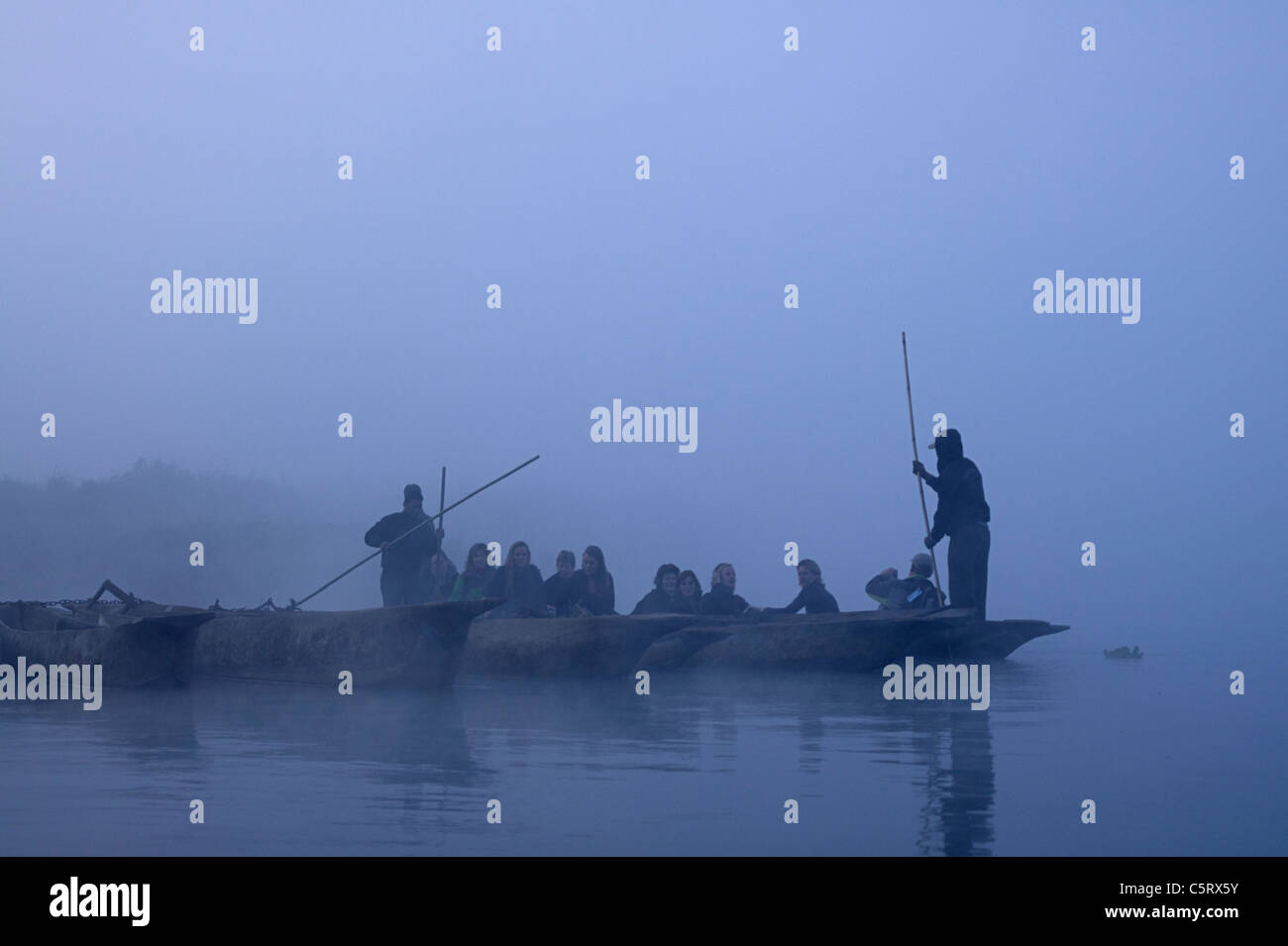 Touristen in hölzernen Kanus im Chitwan Nationalpark, Zentralregion, Nepal Stockfoto