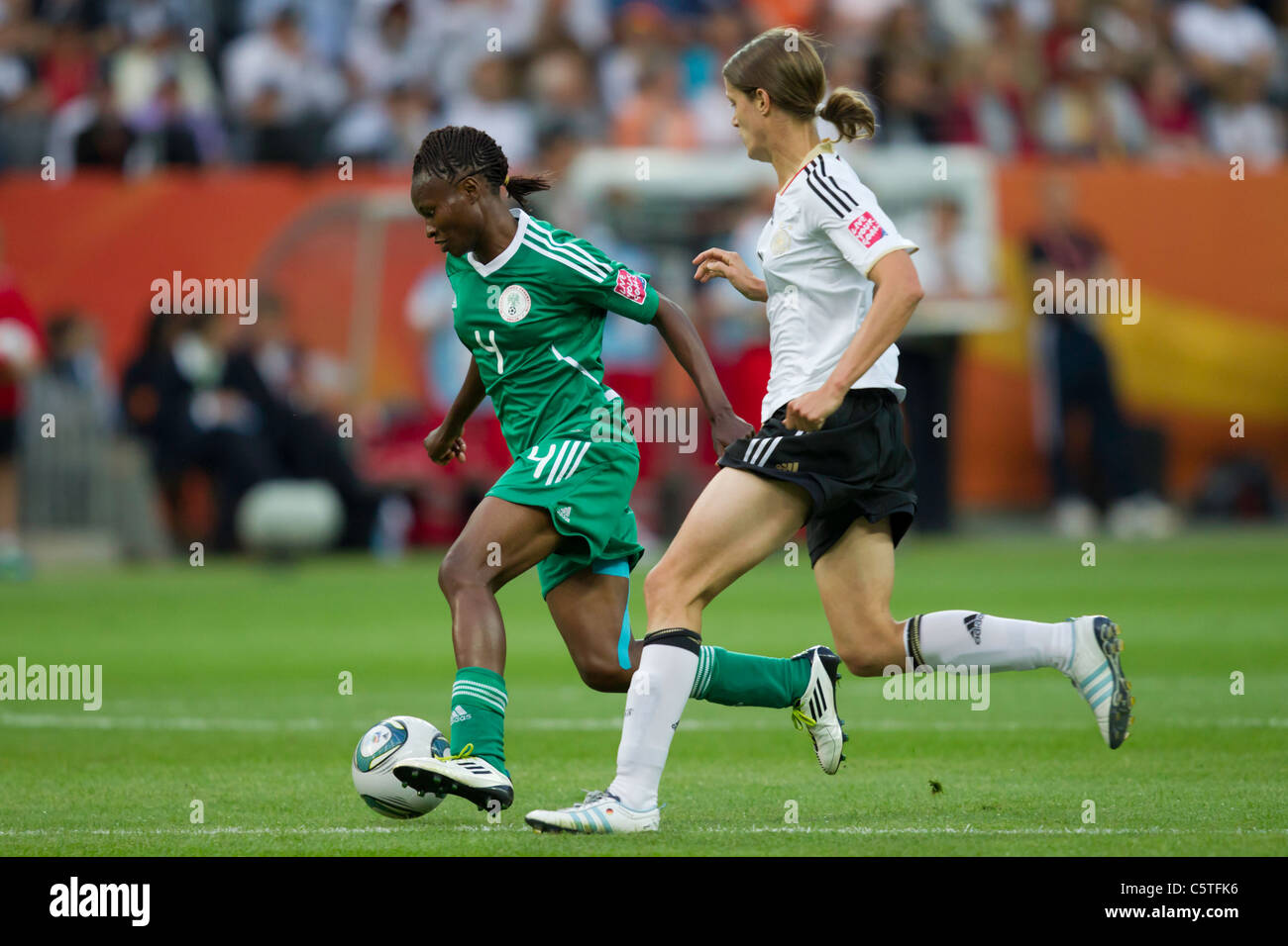 Perpetua Nkwocha von Nigeria (l) treibt den Ball gegen Kerstin Garefrekes der Germany (r) während eines 2011-Frauen-WM-Spiel. Stockfoto