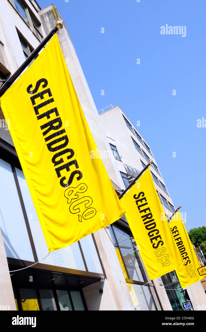 Selfridges & Co Einzelhandelsgeschäft Kaufhaus ikonisches leuchtend gelbes Logo Banner blauer Himmel Sonnentag im West End London England Stockfoto