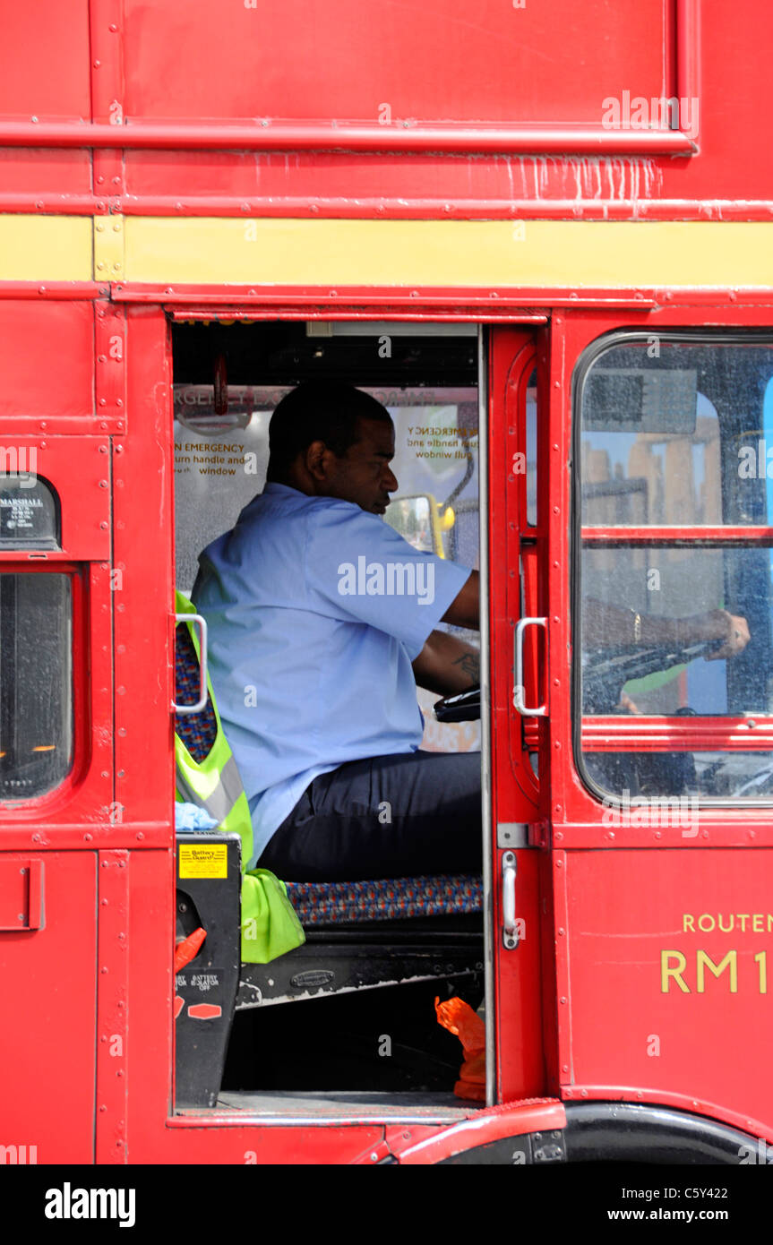 Heißer Sommertag in der Nähe der offenen Tür Treiber-CAB-schwarzer Mann bei der Arbeit fahren Classic Red Double Decker London Transport Routemaster bus England Großbritannien Stockfoto