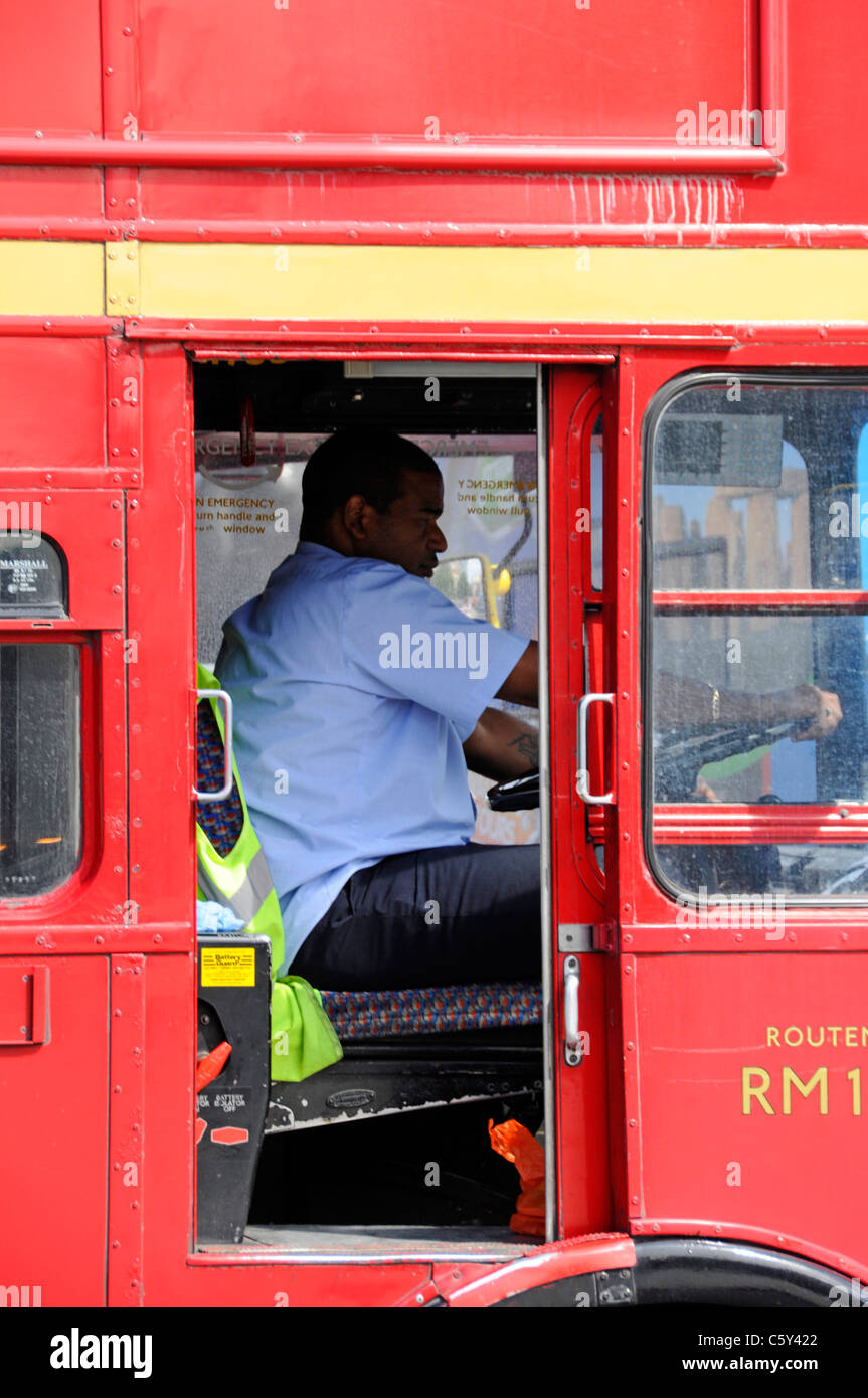 Heißer Sommertag in der Nähe der offenen Tür Treiber-CAB-schwarzer Mann bei der Arbeit fahren Classic Red Double Decker London Transport Routemaster bus England Großbritannien Stockfoto
