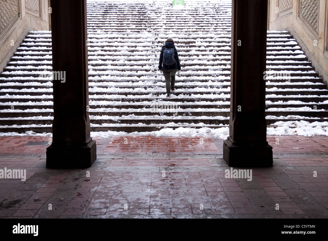 Ein einsame Mädchen geht durch die Bethesda Terrasse Arcade im Schnee im New Yorker winter Stockfoto