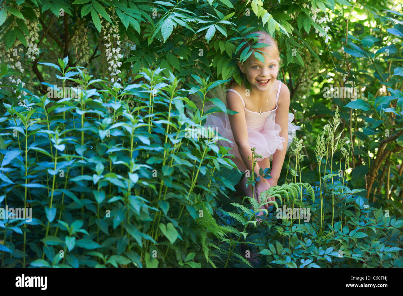 Mädchen in Ballett Kostüm versteckt im Busch Stockfotografie - Alamy