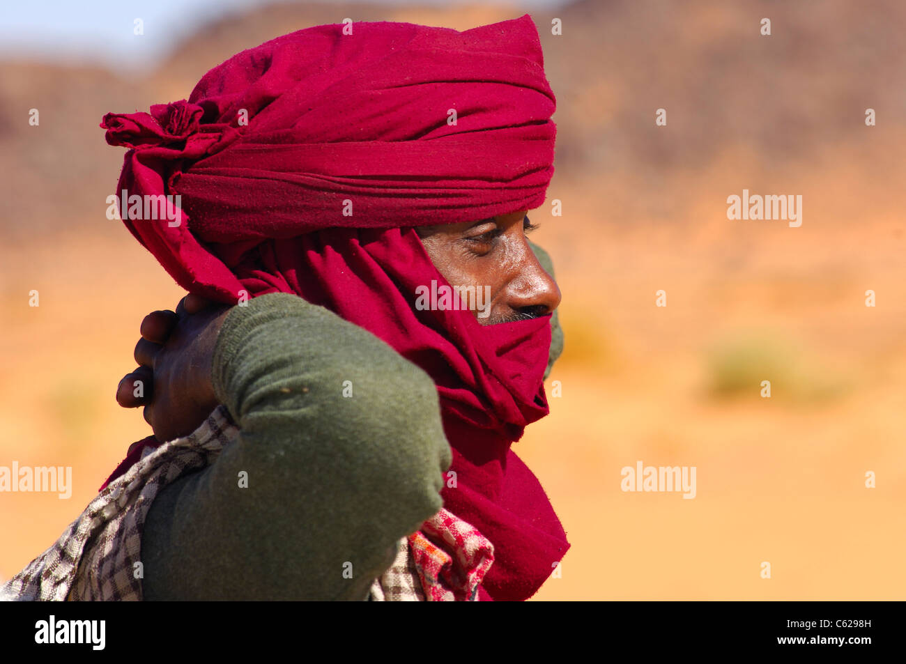 Porträt von einem Tuareg-Mann mit einem roten Chech oder Tagelmust als Headscraf, Sahara Wüste, Libyen Stockfoto