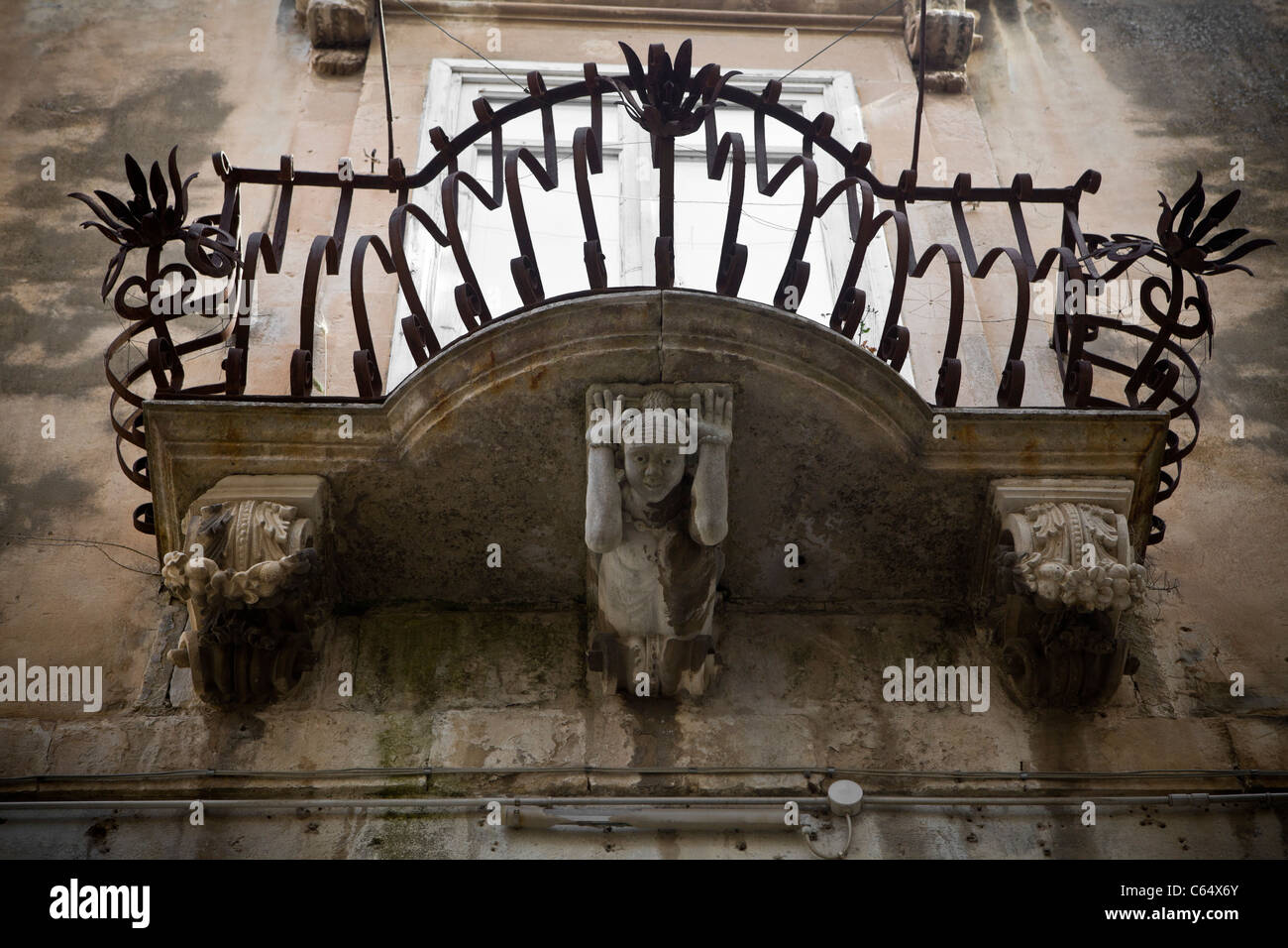 Details zu einem barocken Balkon - Ornamente und Skulpturen in einem sizilianischen Dorf, Mittelmeer, Italien, Europa Stockfoto