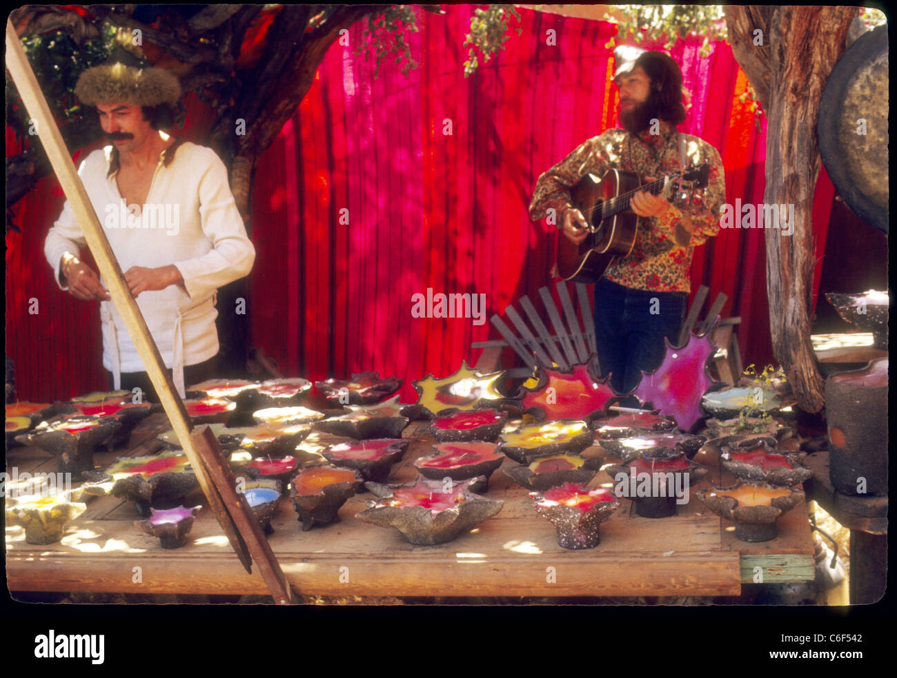 Mann, Verkauf von Kerzen im Stand Renaissance Vergnügen Faire Southern California Hippies 1970er Jahren Gitarre zu spielen Stockfoto