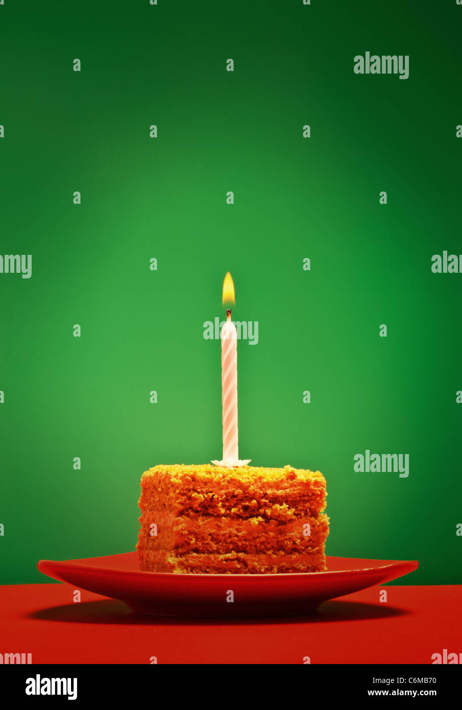 Geburtstagstorte mit Kerzen auf grünem Hintergrund Stockfoto