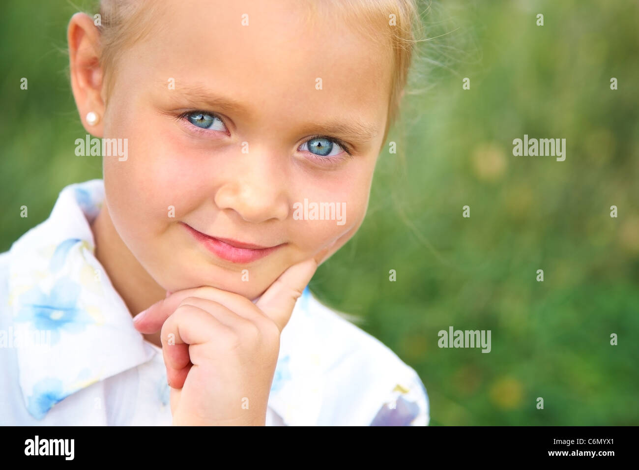 Wunderschöne blauäugige Mädchen süß lächelnd in die Kamera Stockfoto