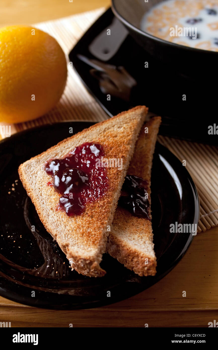 Ein abgerundetes komplette Morgen Frühstück mit Toast mit Marmelade Obst und Müsli. Geringe Schärfentiefe. Stockfoto