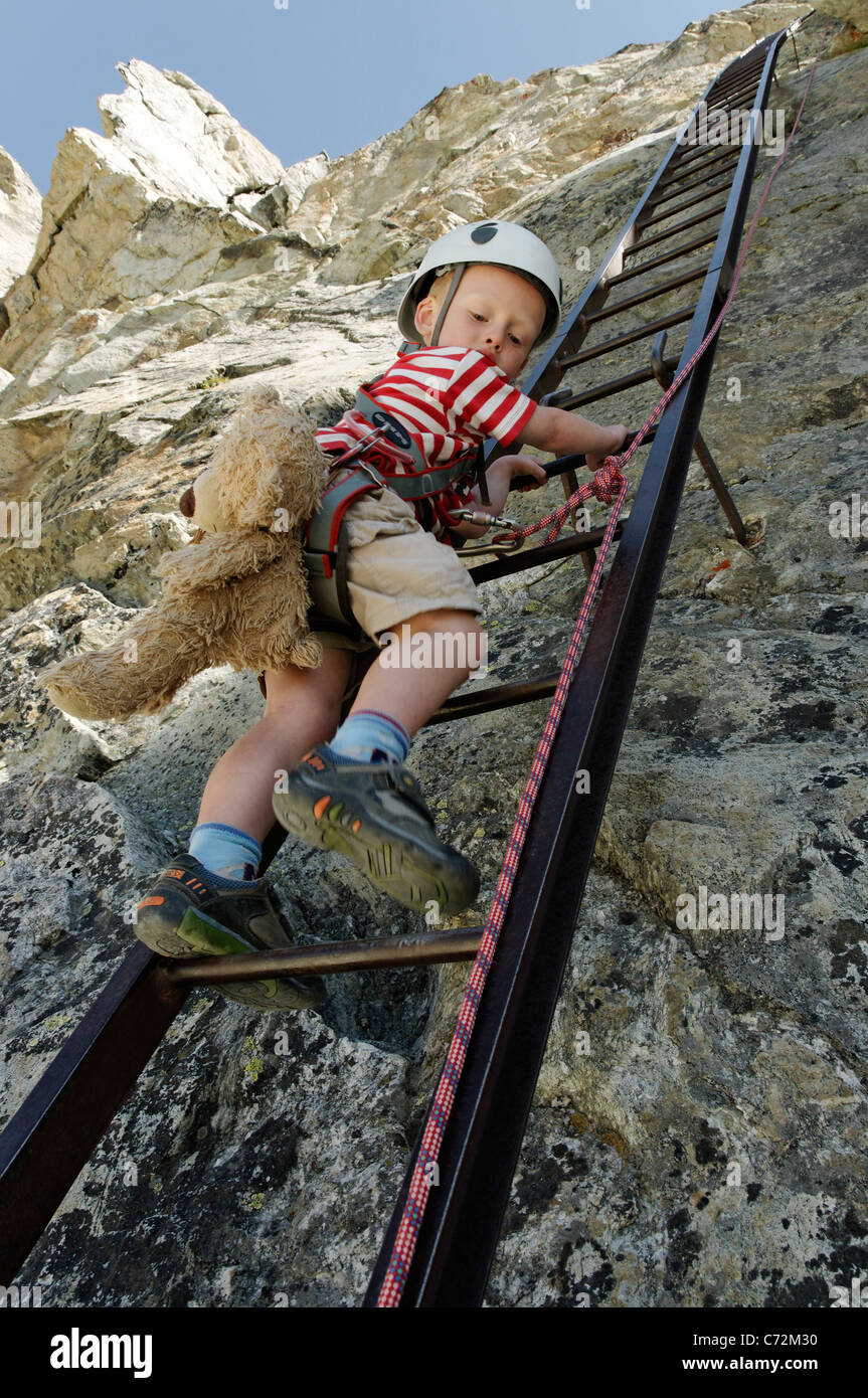 Ein kleiner Junge Klettern hinunter die Leitern an den Pas de Chevres,  Arolla, Schweiz Stockfotografie - Alamy