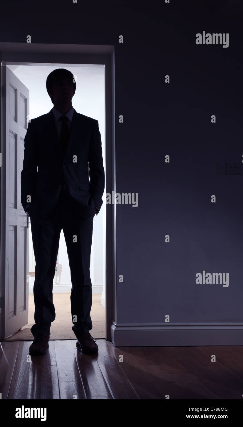 Silhouette eines Mannes steht man vor einer offenen Tür. Stockfoto