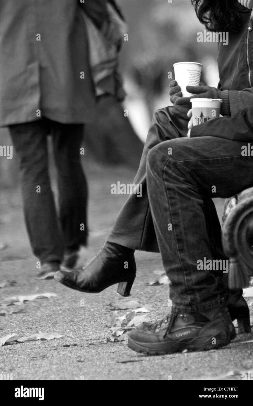 Paar auf Bank im Hyde Park mit einem heißen Getränk Stockfoto