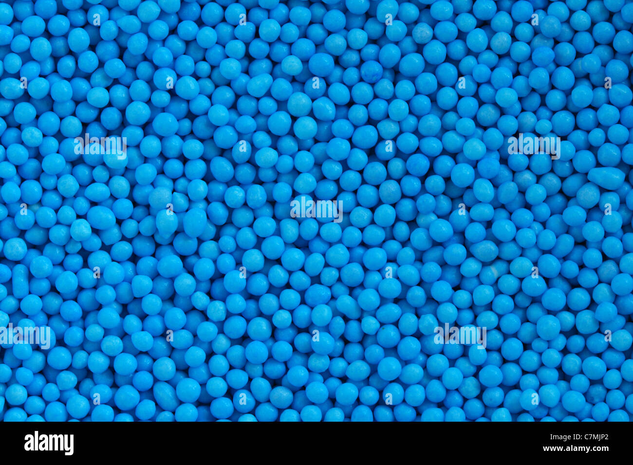 Makro-Foto von winzigen blauen Süßigkeiten bestreuen Kugeln Stockfoto