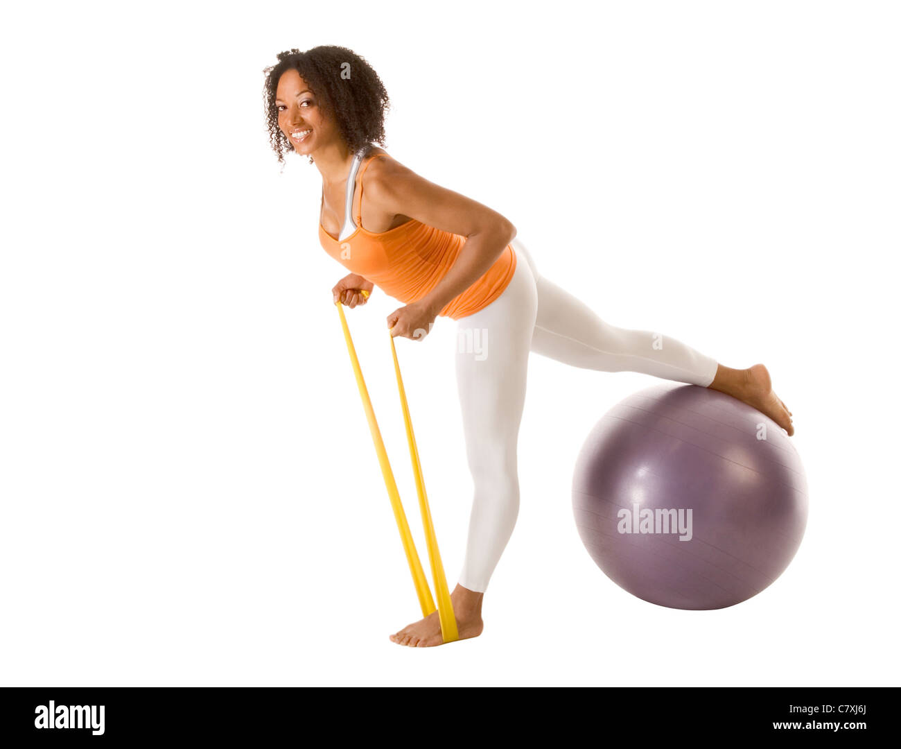Gebräunte weibliche durchführen, stretching Übungen mit Elastikbänder und Sport ball Stockfoto