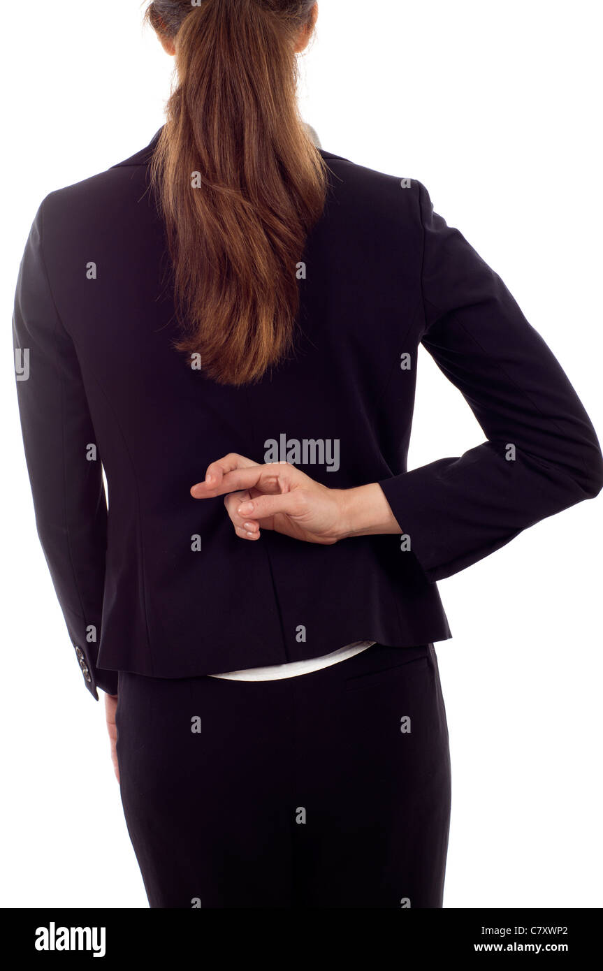 Nahaufnahme von eine Geschäftsfrau mit gekreuzten Fingern hinter ihrem Rücken isoliert auf weißem Hintergrund Stockfoto