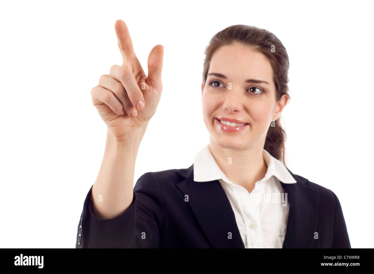 Lächelnde Geschäftsfrau zeigt auf dem Bildschirm zu isoliert auf weißem Hintergrund Stockfoto