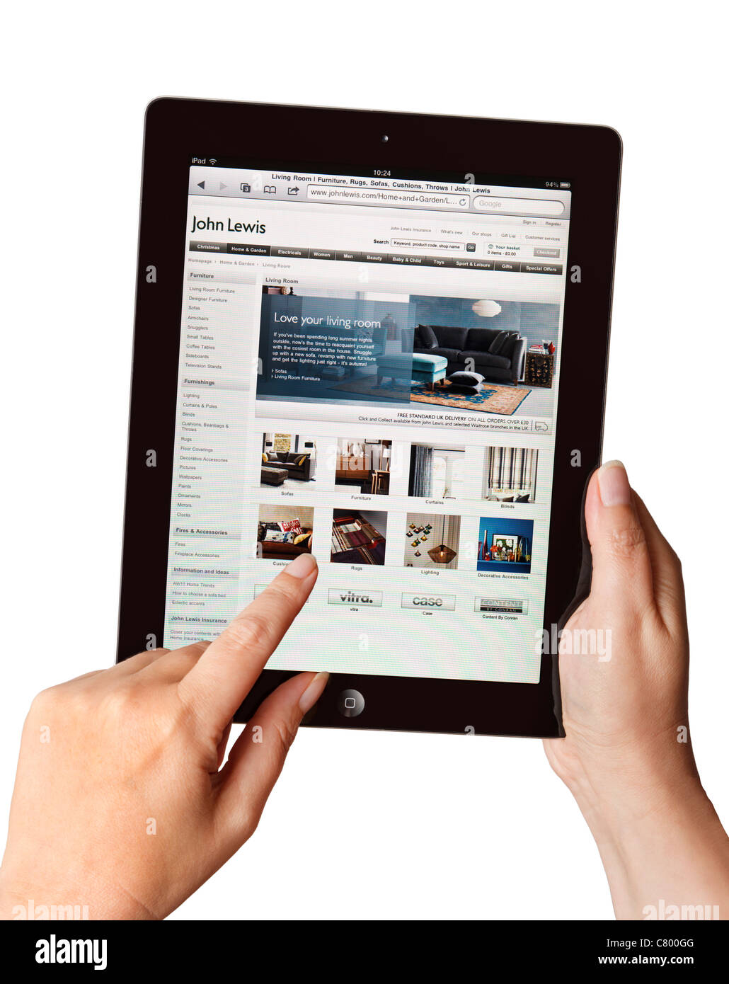 Hände halten ein iPad und mit der John Lewis Website Stockfoto