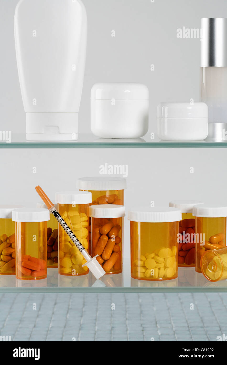 Arzneischrank mit Pille Flaschen und Spritze Stockfoto