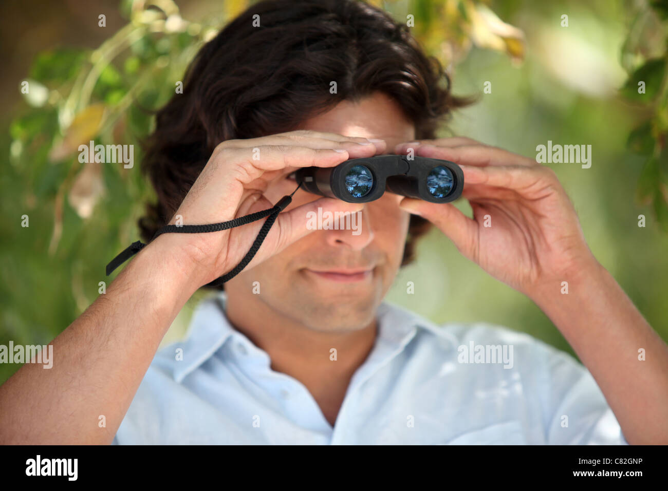 Mann auf der Suche durch ein Fernglas Stockfoto