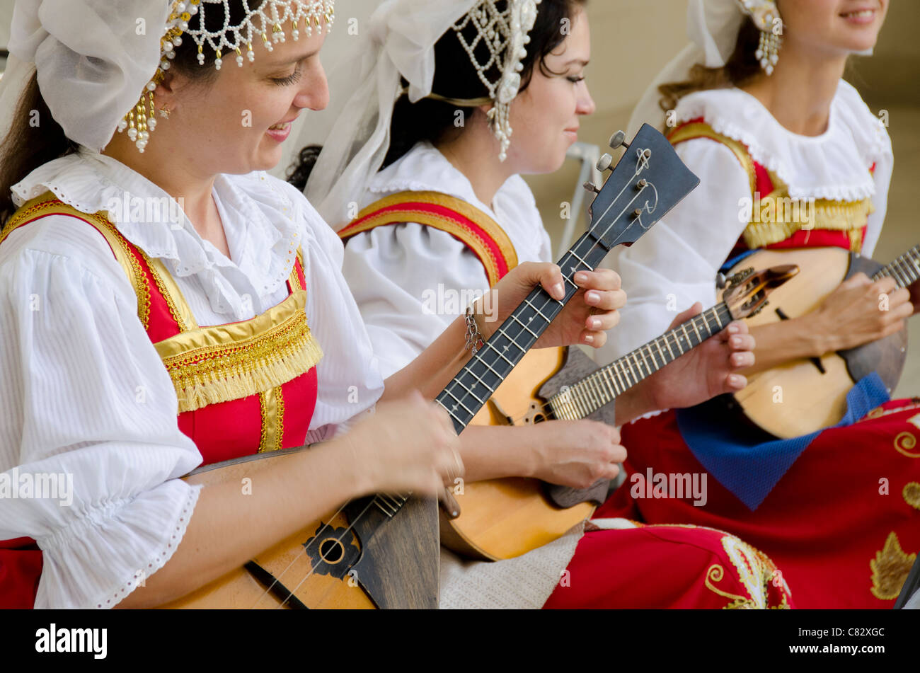 Ukraine, Jalta, Livadia-Palast. Ukrainische Folklore-Show. Frauen in traditionellen Kostümen spielen russische Balalaikas und lauten. Stockfoto