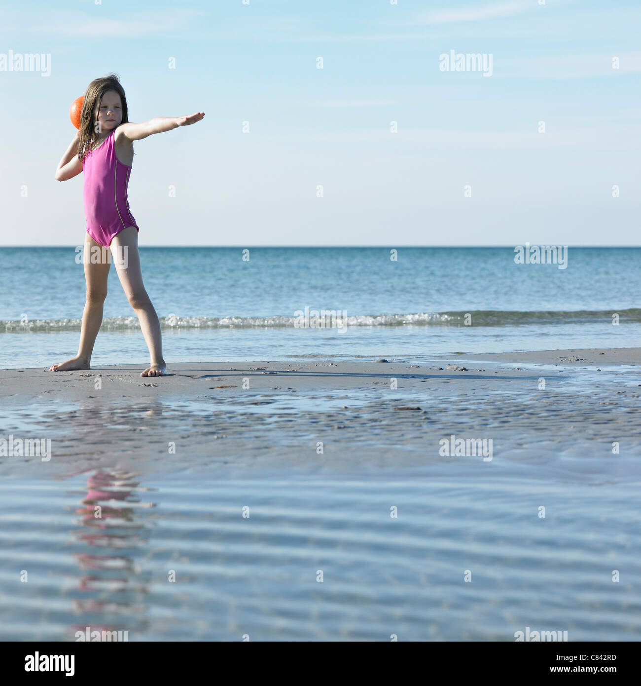 Mädchen spielen mit Ball am Strand Stockfoto