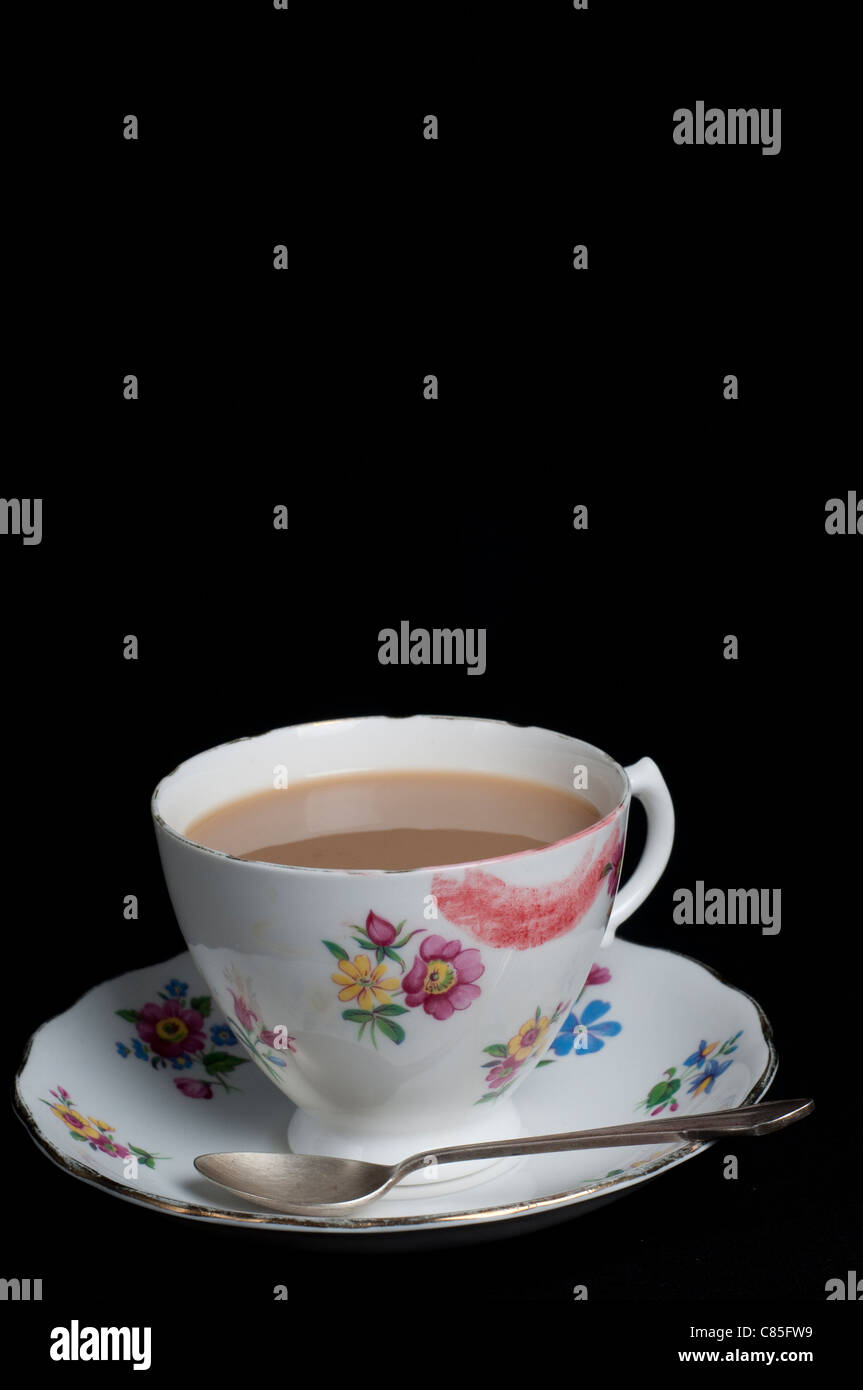 Tasse Tee mit Lippenstift und Teelöffel Stockfoto