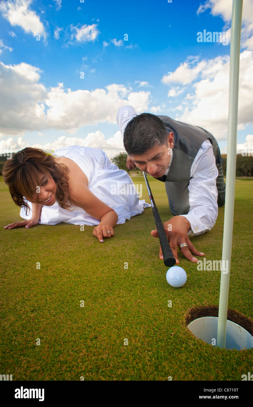 Braut und Bräutigam lustige Hochzeit imitieren Poolbillard auf Golfplatz Stockfoto