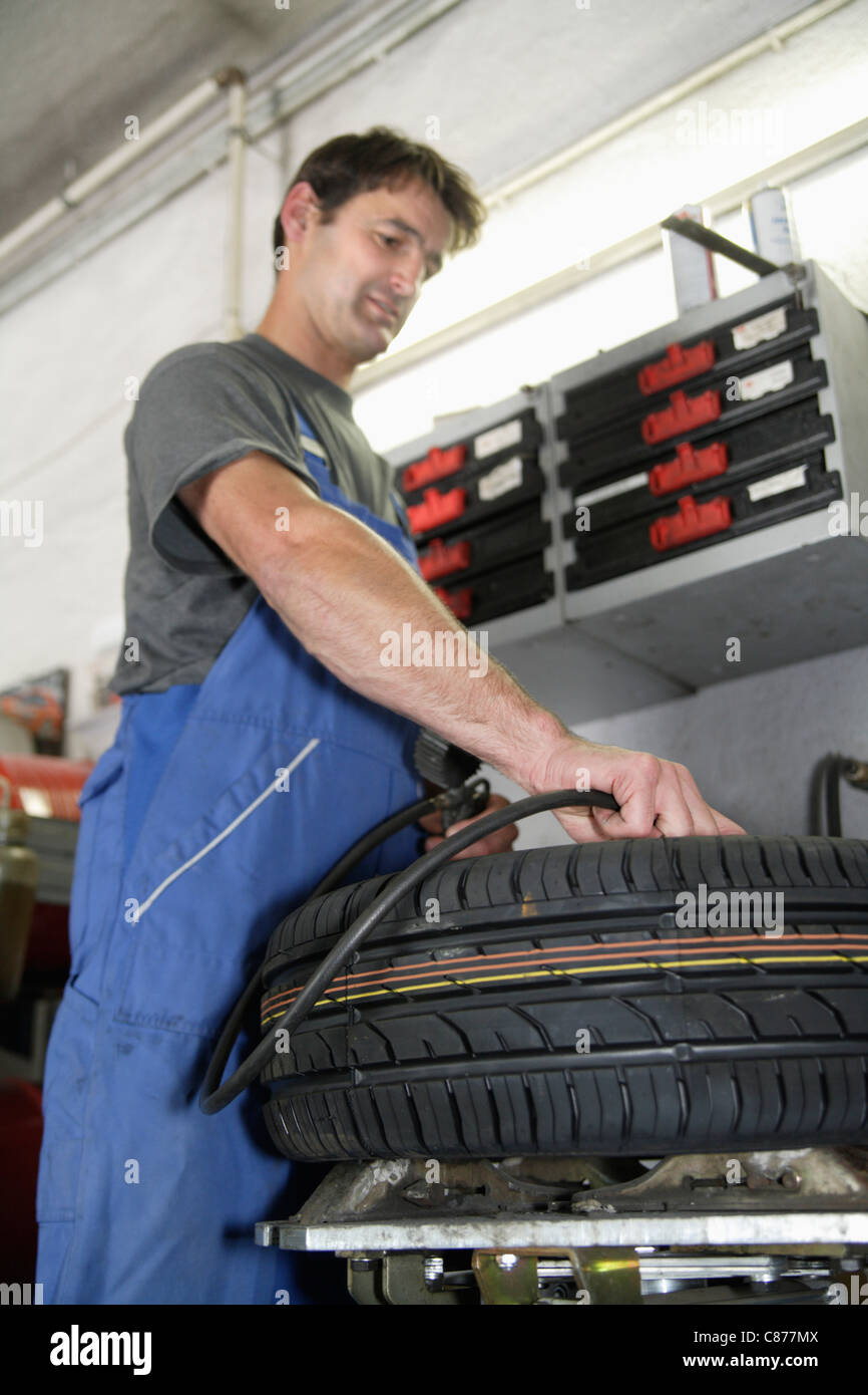 Deutschland, Ebenhausen, Mechatroniker arbeiten an Reifen in Pkw-garage Stockfoto