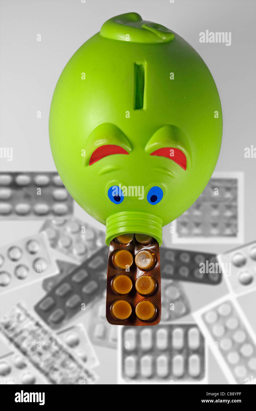 Tabletten in Blister-Packungen mit einem Sparschwein, Konzept Stockfoto