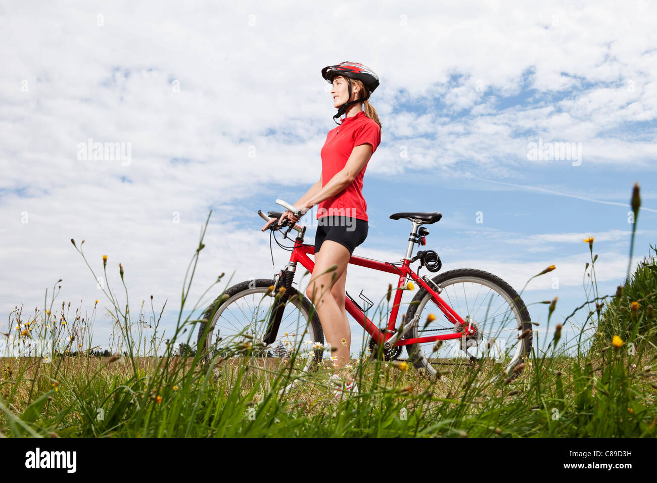 Deutschland, Bayern, junge Frau, die zu Fuß, mit Mountainbike Stockfoto
