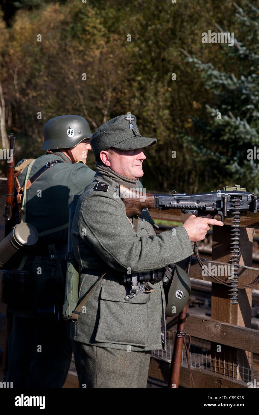 Die Deutschen bei 'Le Visham' oder Levisham im Oktober, 2011 _kostümierte Soldaten Mann MG 42 Maschinengewehr, Weltkrieg zwei Waffen, Zweiten Weltkrieg, Zweiten Weltkrieg, Zweiten Weltkrieg, WW2 Re-enactors bei der Pickering war und Kriegswochenende, North Yorkshire, Großbritannien Stockfoto