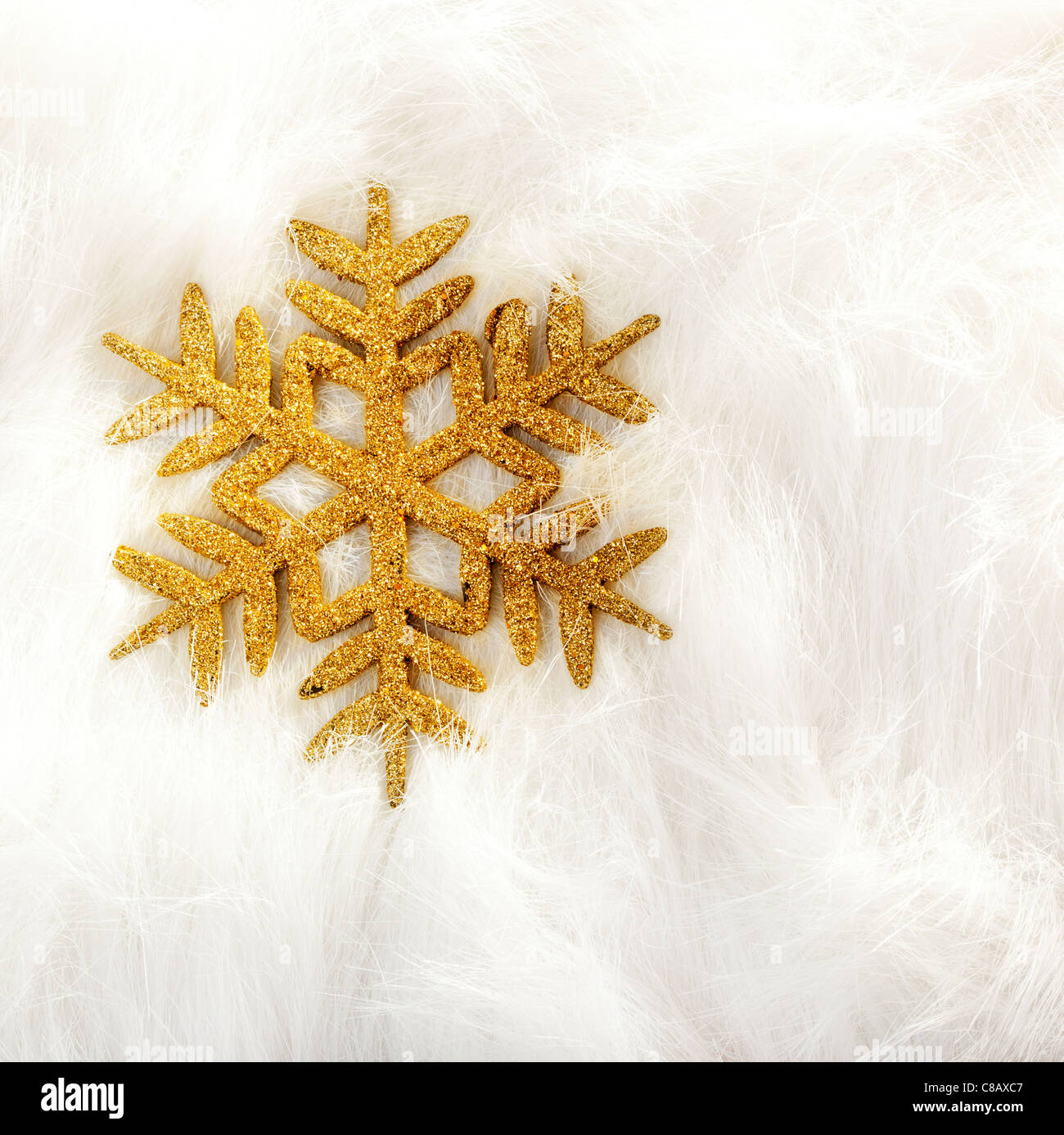 Goldene Weihnachten Schneeflocke auf weißem Fell Hintergrund Stockfoto