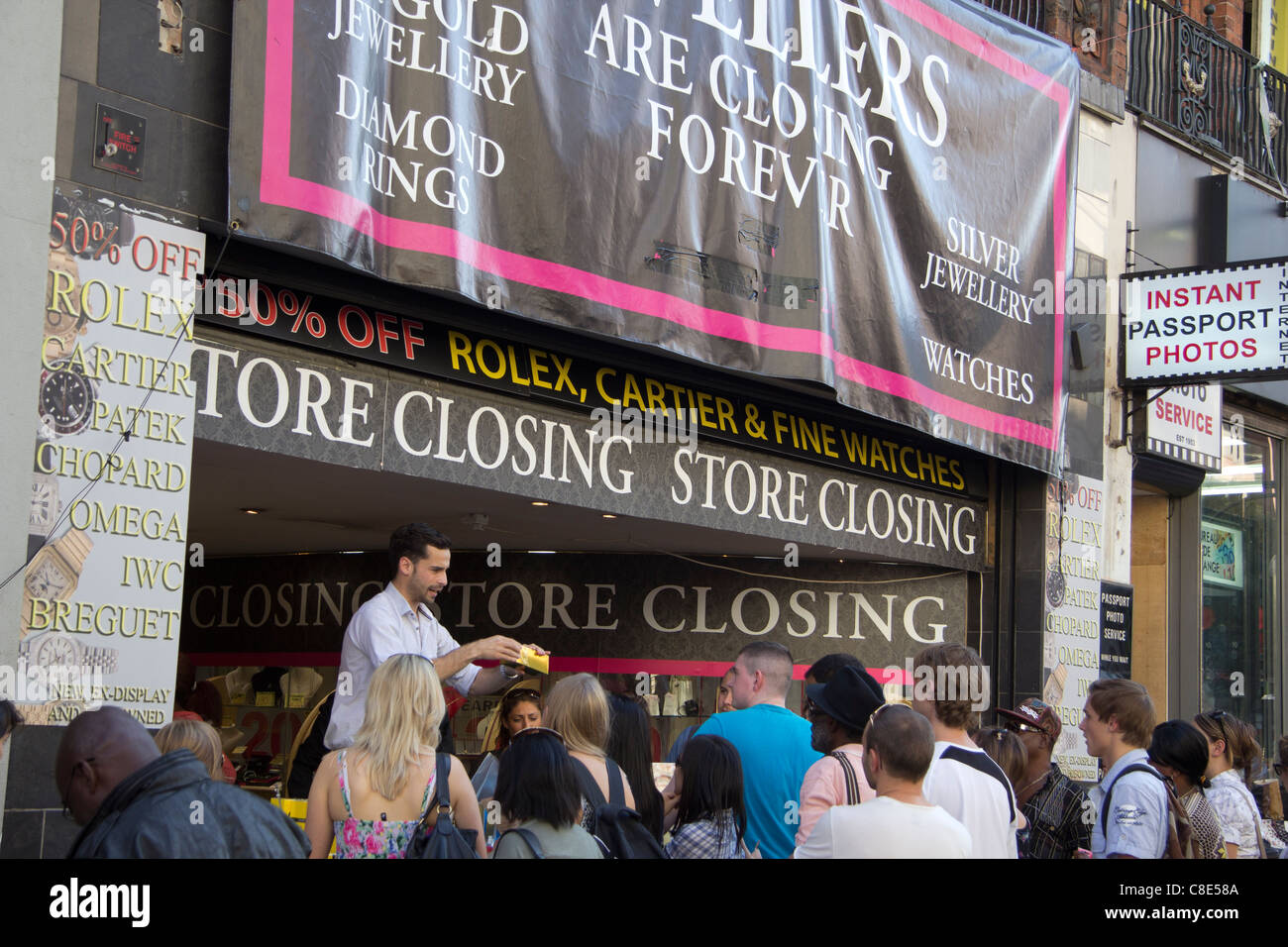 Ein "Schließung Verkauf" abzielen, Touristen auf der Oxford Street, der am meisten frequentierte Einkaufsstraße in London. Stockfoto