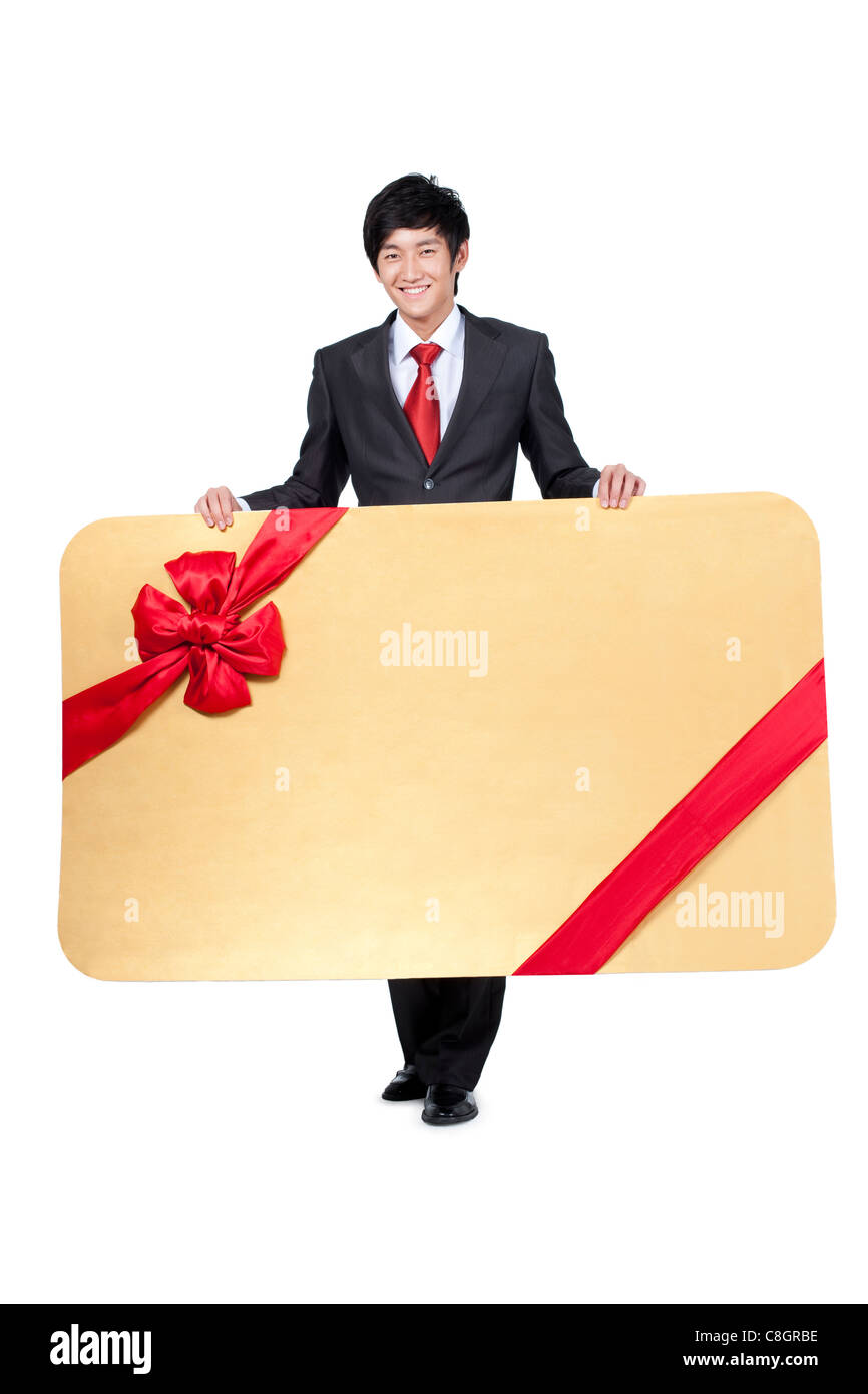 Glücklich Kaufmann mit einem übergroßen gewickelt Karte Stockfoto
