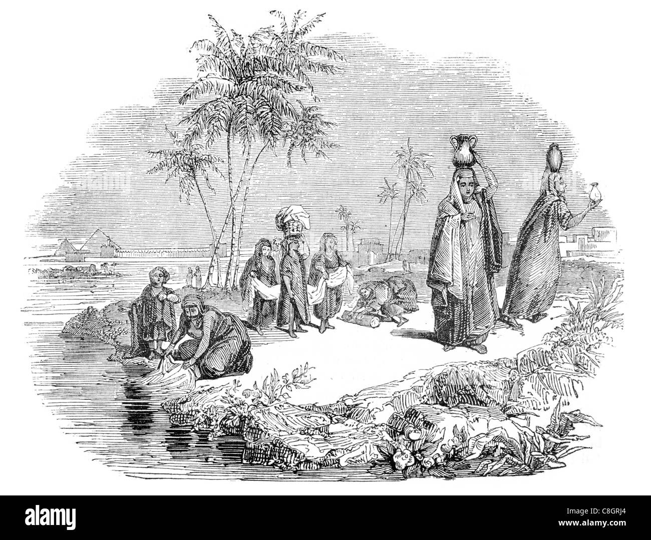 Ägyptische Frauen waschen und bleichen an der Fluss Nil Scheibe Reinigung sauberer Stoff Kleidung Tuch Schmutz waschen Stockfoto