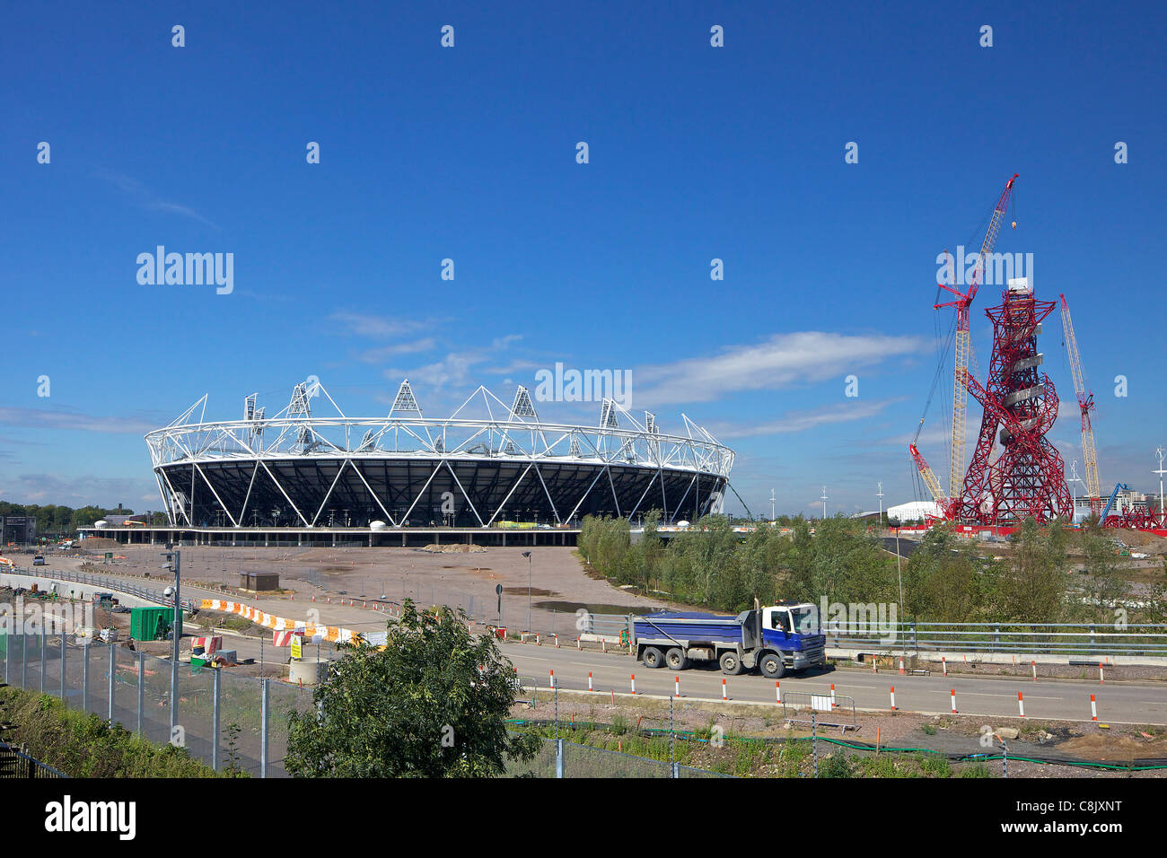 Bau-Verkehr in der Nähe des Olympiastadions 2012 und der ArcelorMittal Orbit von Anish Kapoor, Olympiapark, Stratford, Stockfoto