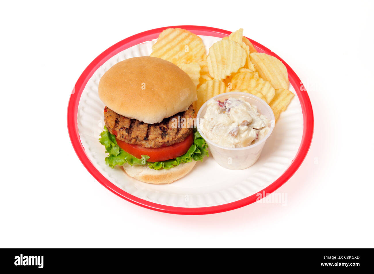 Veggie-Burger mit Salat und Tomate in Brötchen in einem roten Retro-Kunststoffplatte Korb auf weißem Hintergrund, gegrillte Ausschnitt. Stockfoto