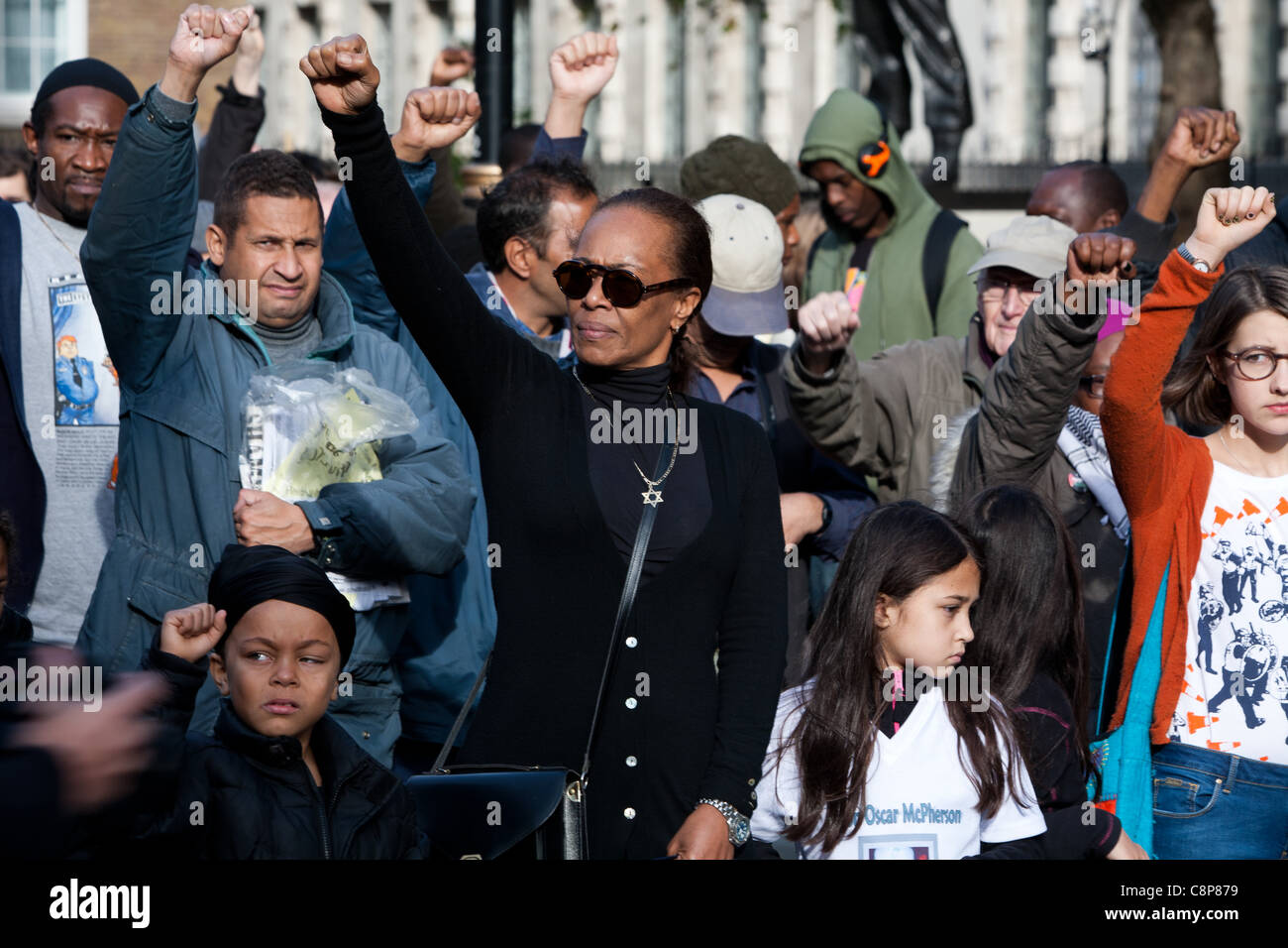 London, UK, 29.10.2011. NCAPV Demonstranten mit ihren Fäusten in der Luft in der Weise einer "Black Power Salute" außerhalb Downing St. Stockfoto