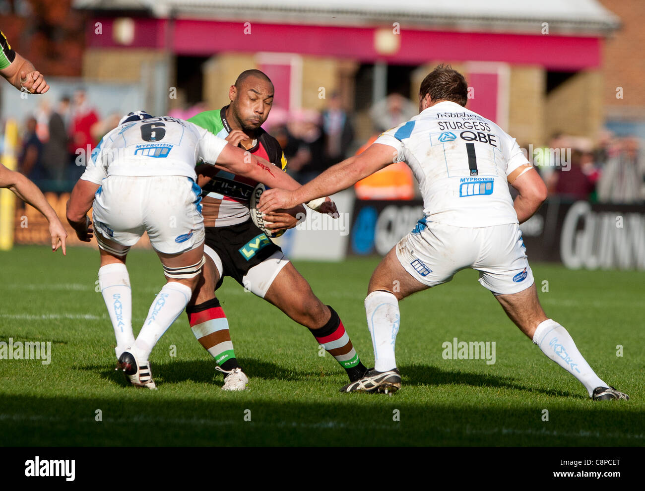 Harlequins Jordan Turner Hall versucht, die Grenze zwischen Brett Sturgess und Tom Johnson von Exeter und England zu brechen Stockfoto