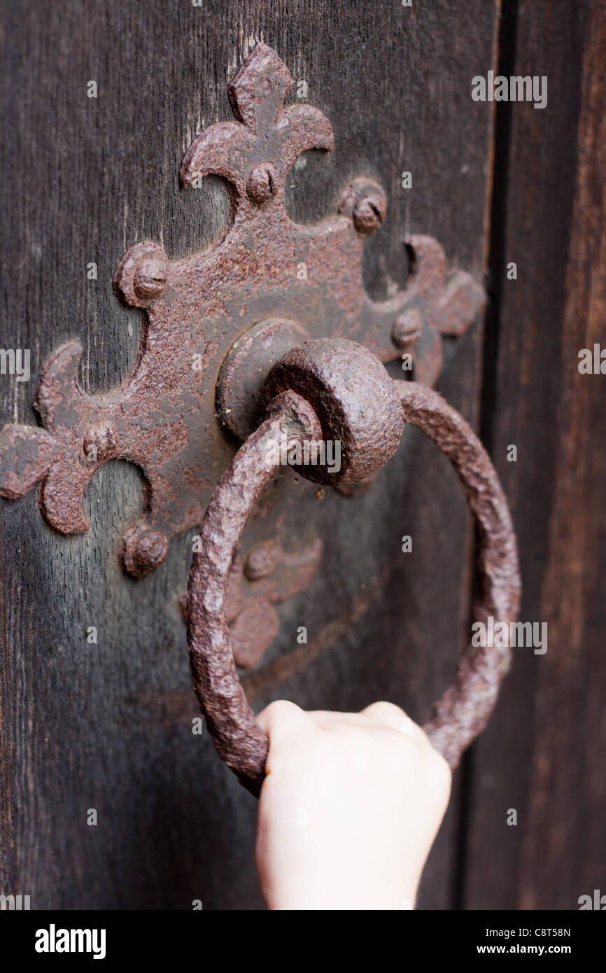 Eine alte rostige Türklopfer an einer hölzernen Kirche Tür Stockfoto