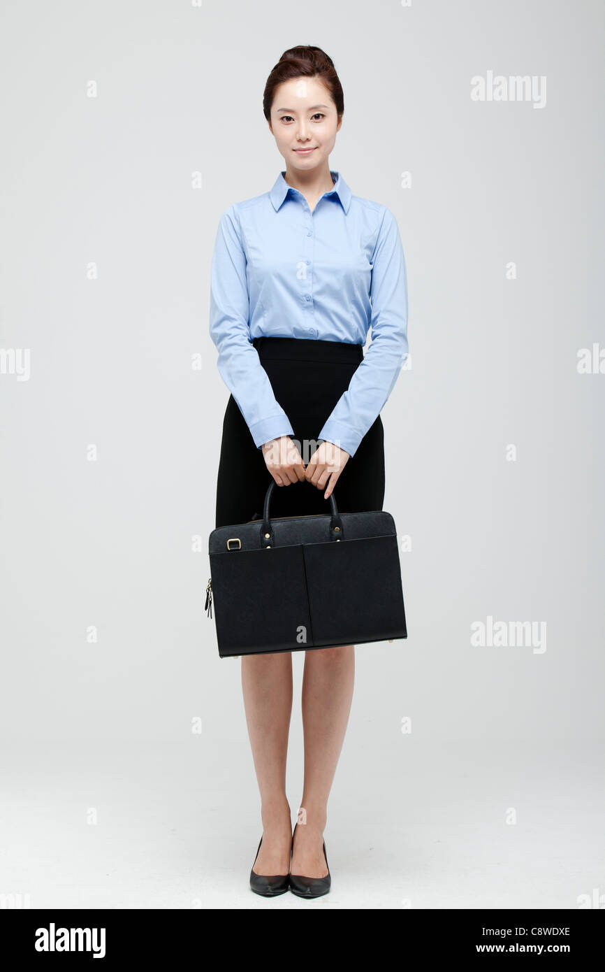 Asiatische Geschäftsfrau, die Koffer In der Hand halten Stockfoto