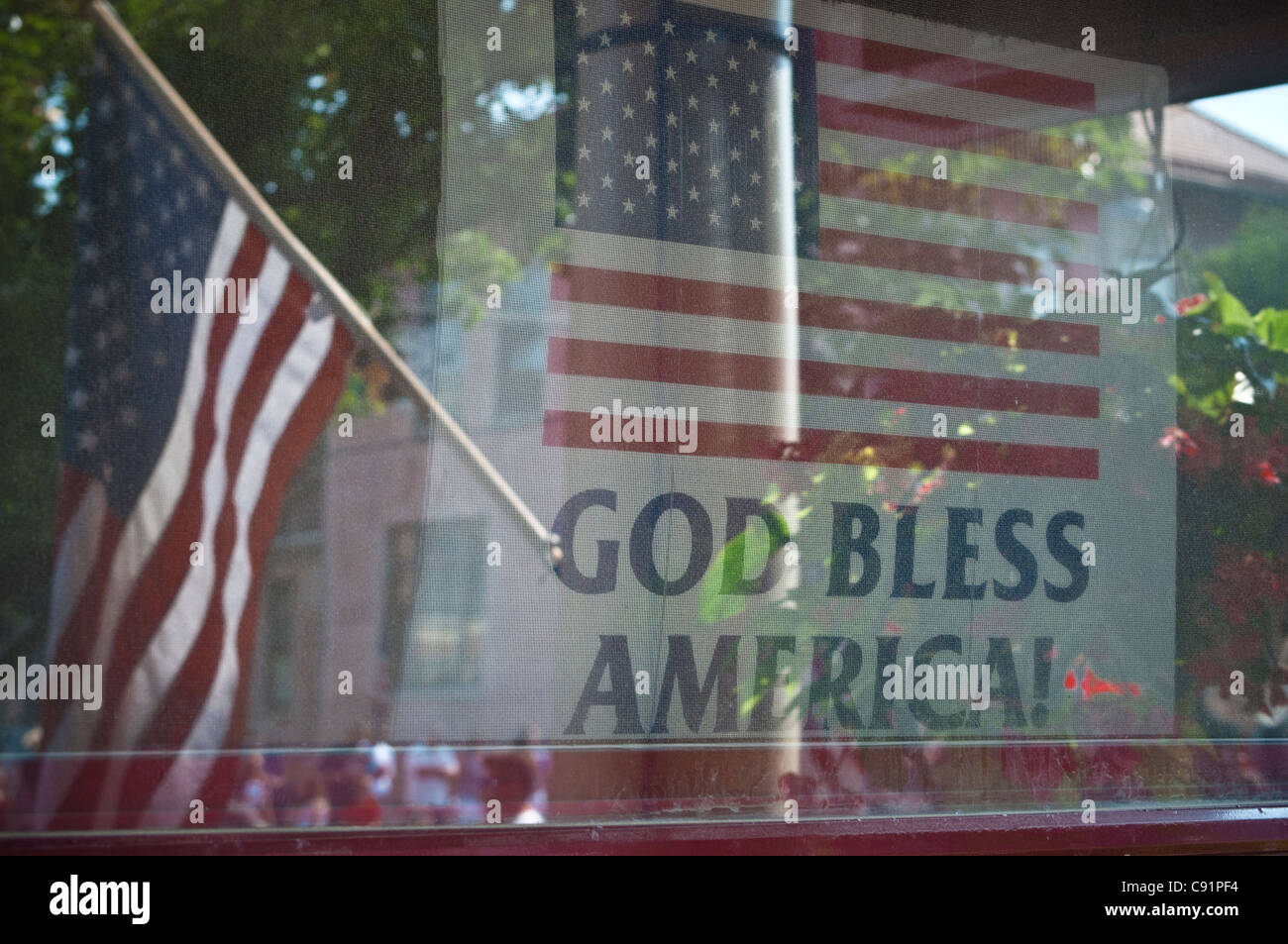 Kleine Stadt, Vorstadt, Patriotische Feiertage Parade. Gott segne Amerika Fenster Schilder, Poster, Stockfoto