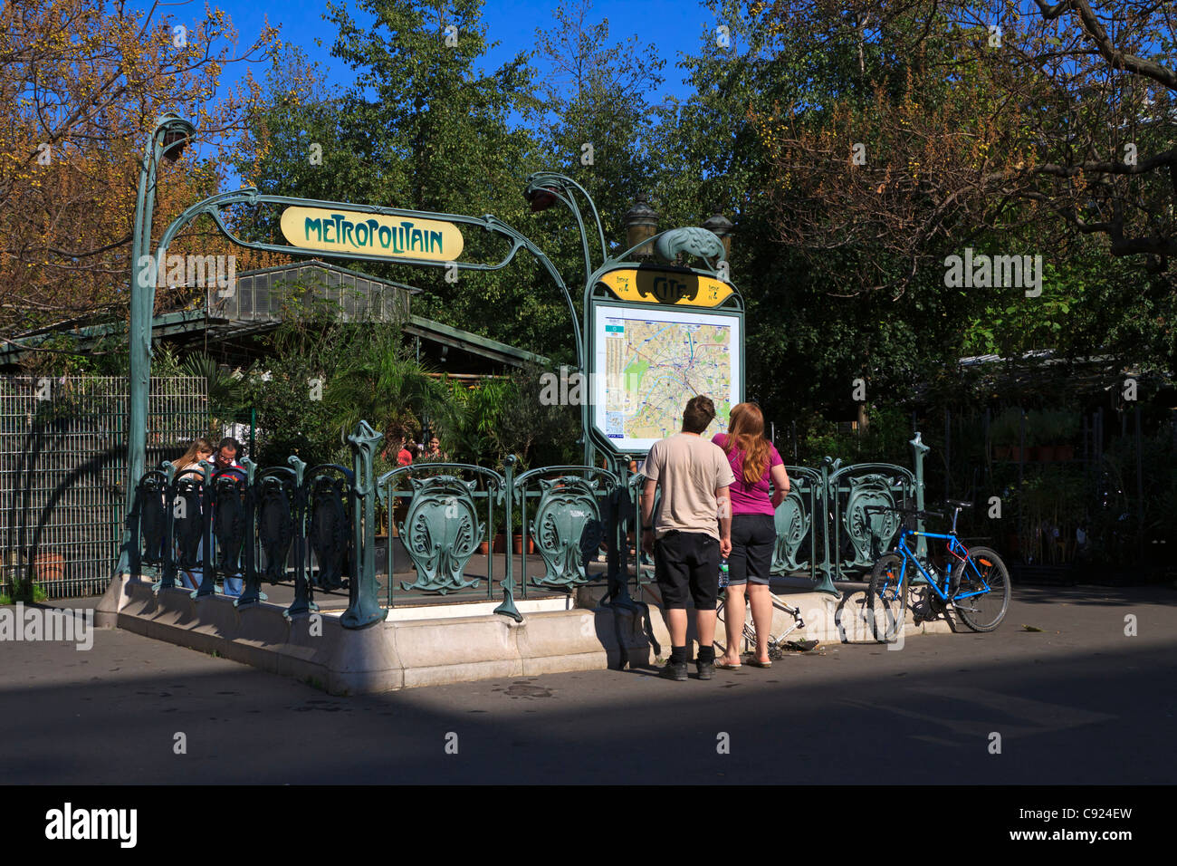 Einer der Eingänge Jugendstil Metro Station auf der Ile De La Cite, Paris. Touristen besuchen Sie die Landkarte an einem Herbstmorgen. Stockfoto