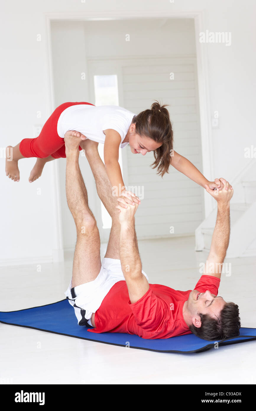 Vater und Tochter beim Yoga heben Stockfoto