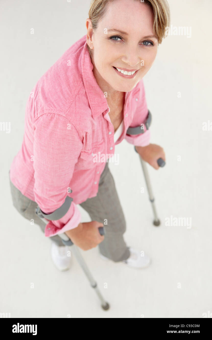 Frau gehen mit Krücken Stockfoto