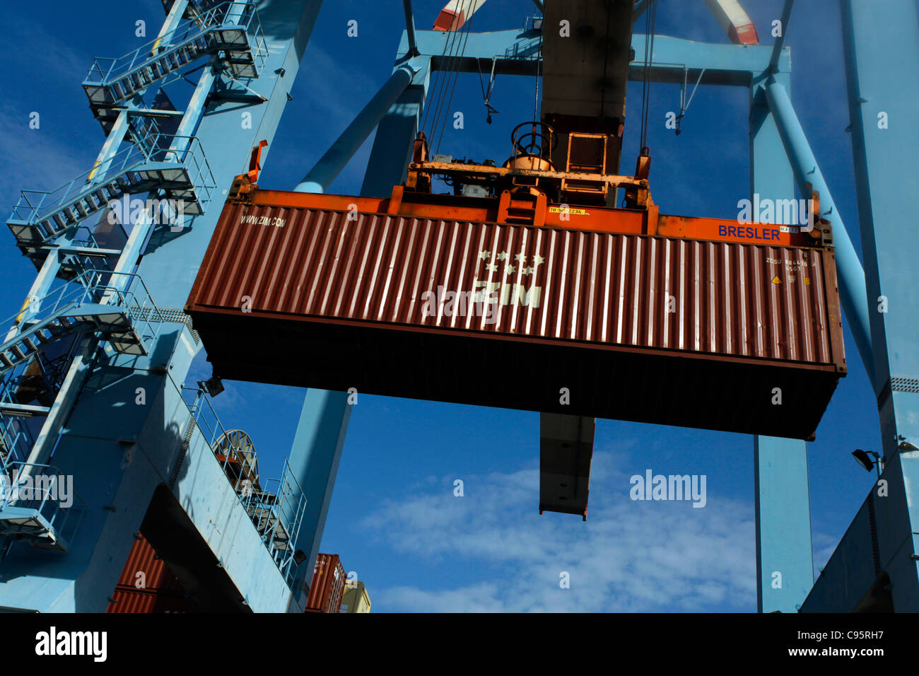 Ein Container der größten Frachtschifffahrtsgesellschaft von Zim Israel wird mit einem riesigen Kran am Frachtterminal im Hafen von Haifa, dem größten Seehafen Israels, beladen Stockfoto