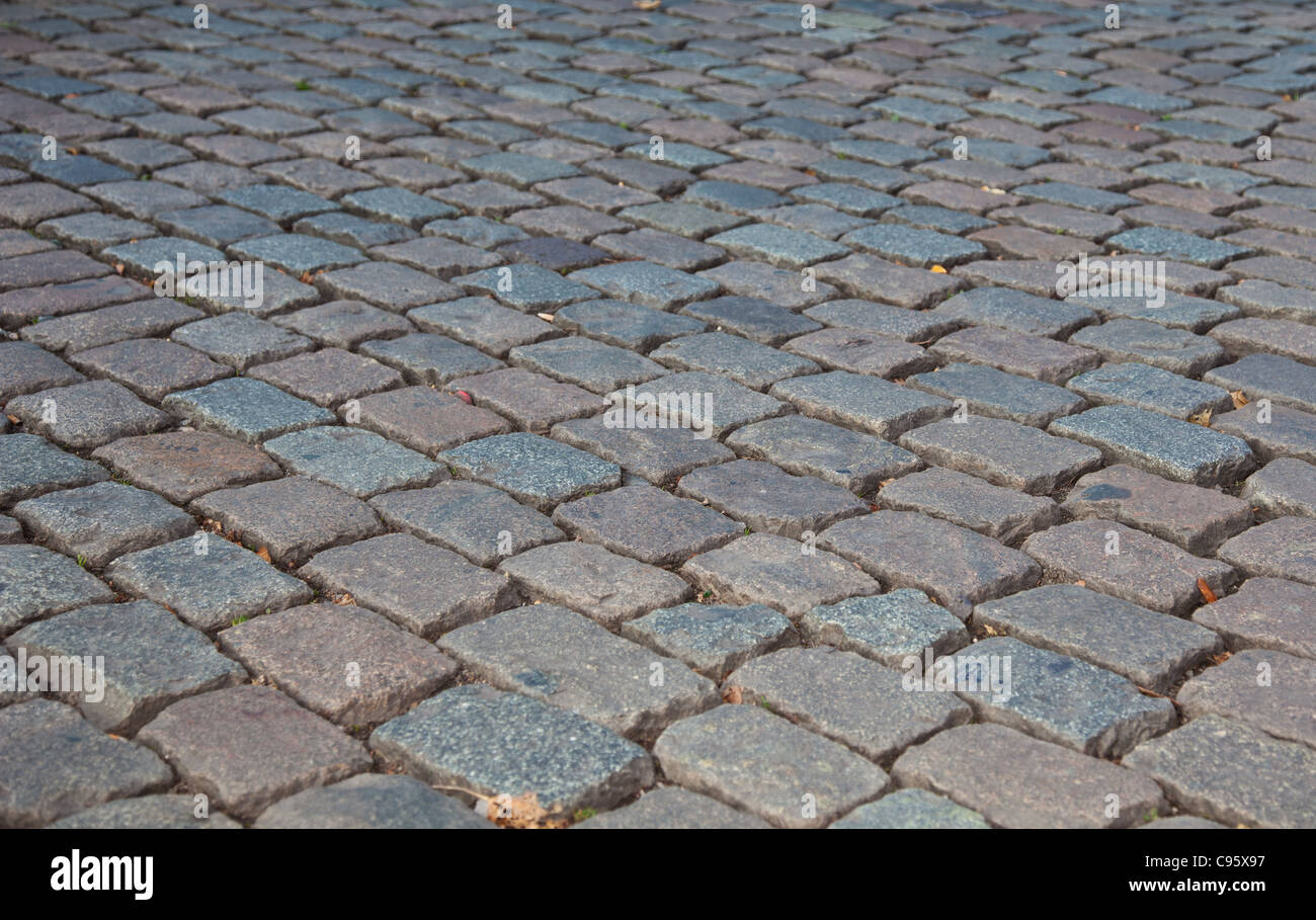 Graue Kopfsteinpflaster, Hintergrundtextur. Stockfoto