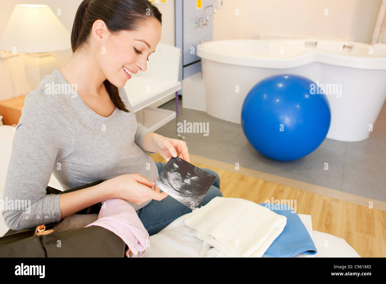 Hausgeburt. Schwangere Frau in ihrem Zimmer bei einer Hausgeburt Auspacken. Stockfoto