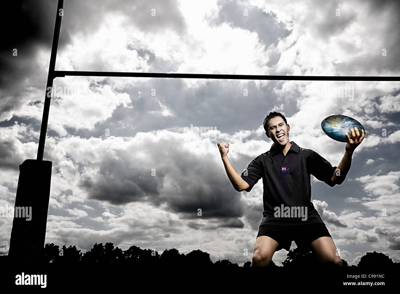 Rugby-Spieler mit Welt auf Rugby-ball Stockfoto